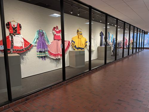 A display of traditional dresses from Latino and Hispanic cultures.