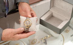jeweler holding fine watch