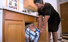 Woman with recycling bag in apartment kitchen