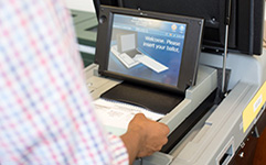 A person puts his ballot into the ballot machine.