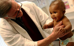 doctor examining infant