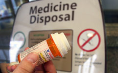 Pill bottle at medicine disposal box