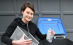 Woman emptying items into recycling bin