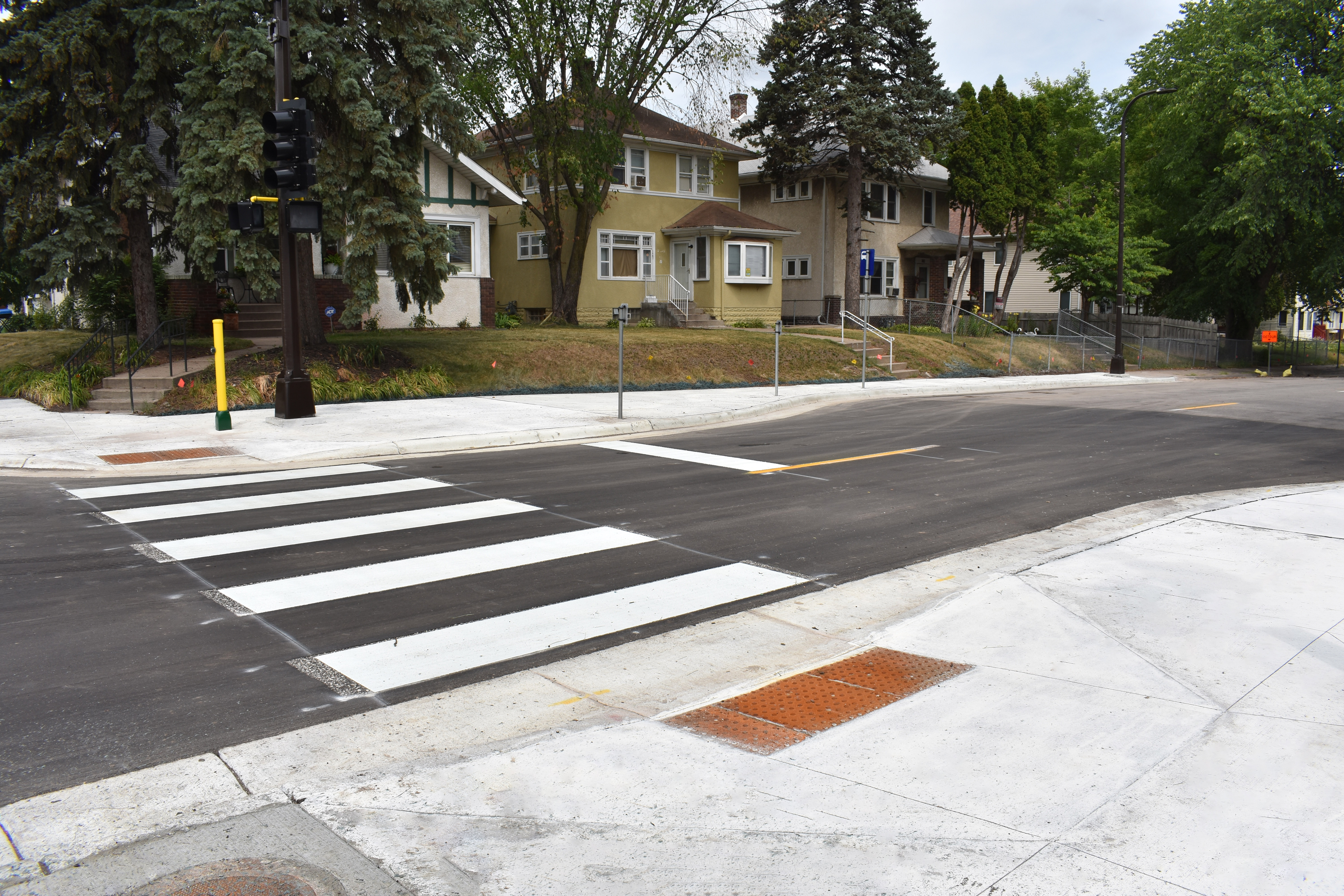 Concrete curb extensions or "bump-outs" on Penn Avenue at the 14th Street intersections to reduce crosswalk distance and improve access for people walking and rolling.
