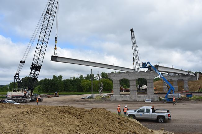 Crews set the bridge beams on the new County Road 92 bridge over Highway 12