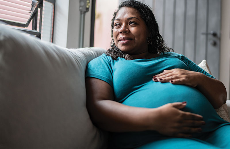 pregnant women sitting on a couch