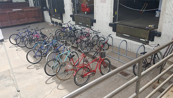 several bicycles parked outside of a loading dock