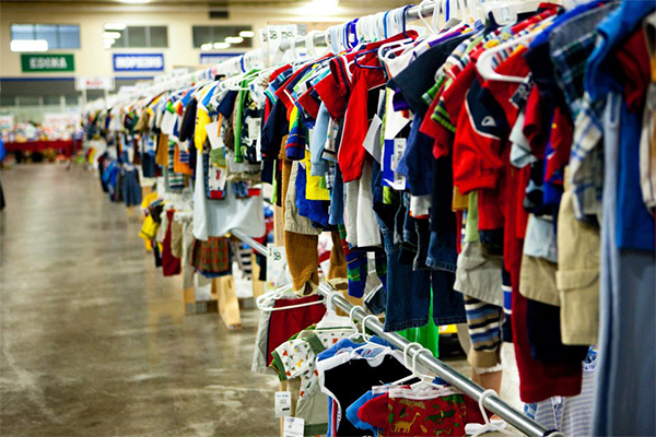 children's clothing hung up on a long clothing rack
