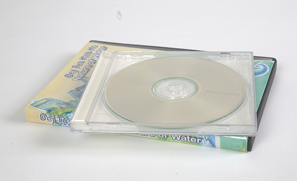 A DVD in a case with a blank CD in its case on top