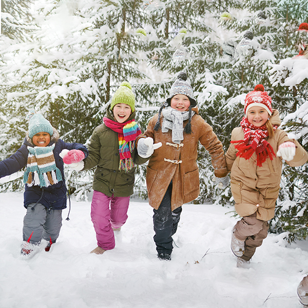 kids walking in the snow with arms linked