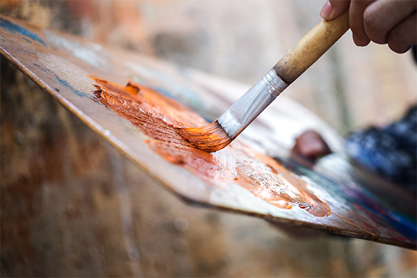 paint palette with someone holding a paint brush