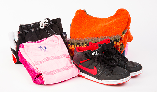 folded clothes and pair of shoes