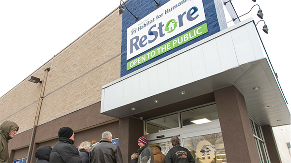 outside of restore building with people waiting in line