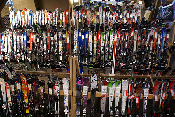skis sitting upon 3 different racks