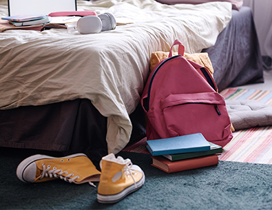 shoes and backpack sitting on kids' bedroom floor