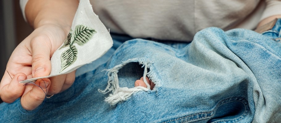  A woman holds a piece of fabric in her hand.