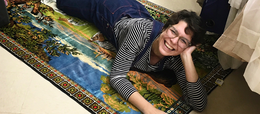 Amanda Baumnn laying on a colorful rug