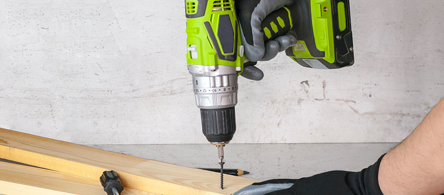 Using a drill to drill into lumber