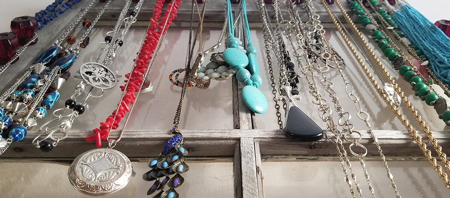 necklaces hanging on window pane