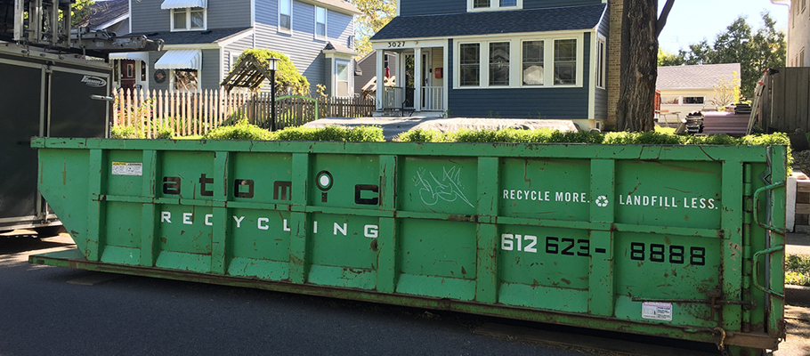 Large dumpster reading "Atomic Recycling"