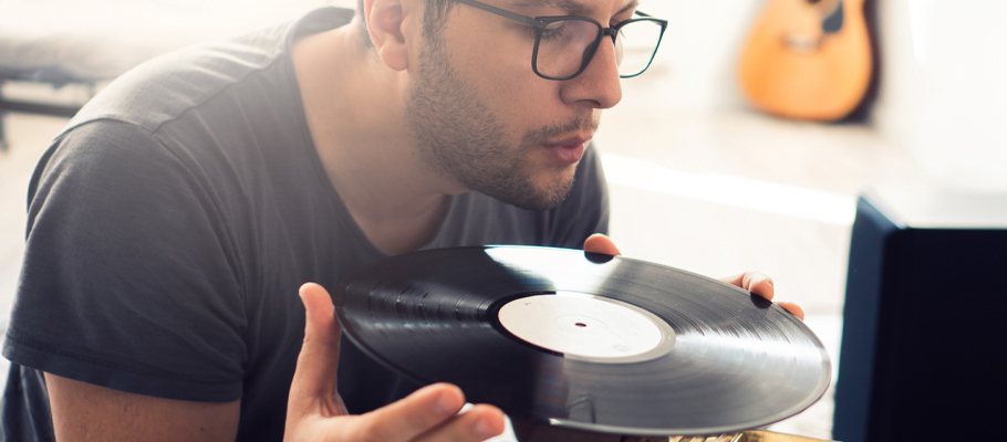 Man inspecting the quality of a vinyl record