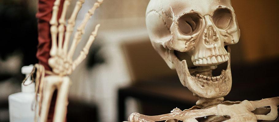 Skeleton statue waving at camera