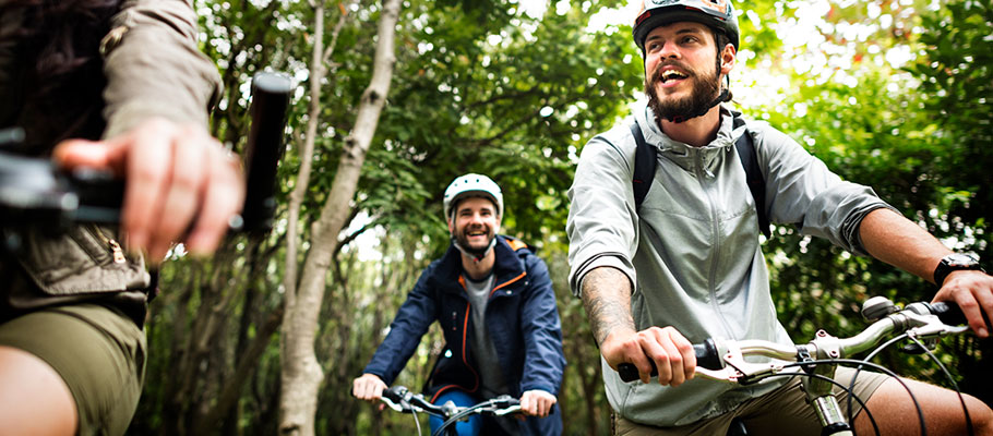 People smiling on mountain bikes