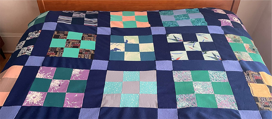 Brightly colored handmade quilt using old clothing