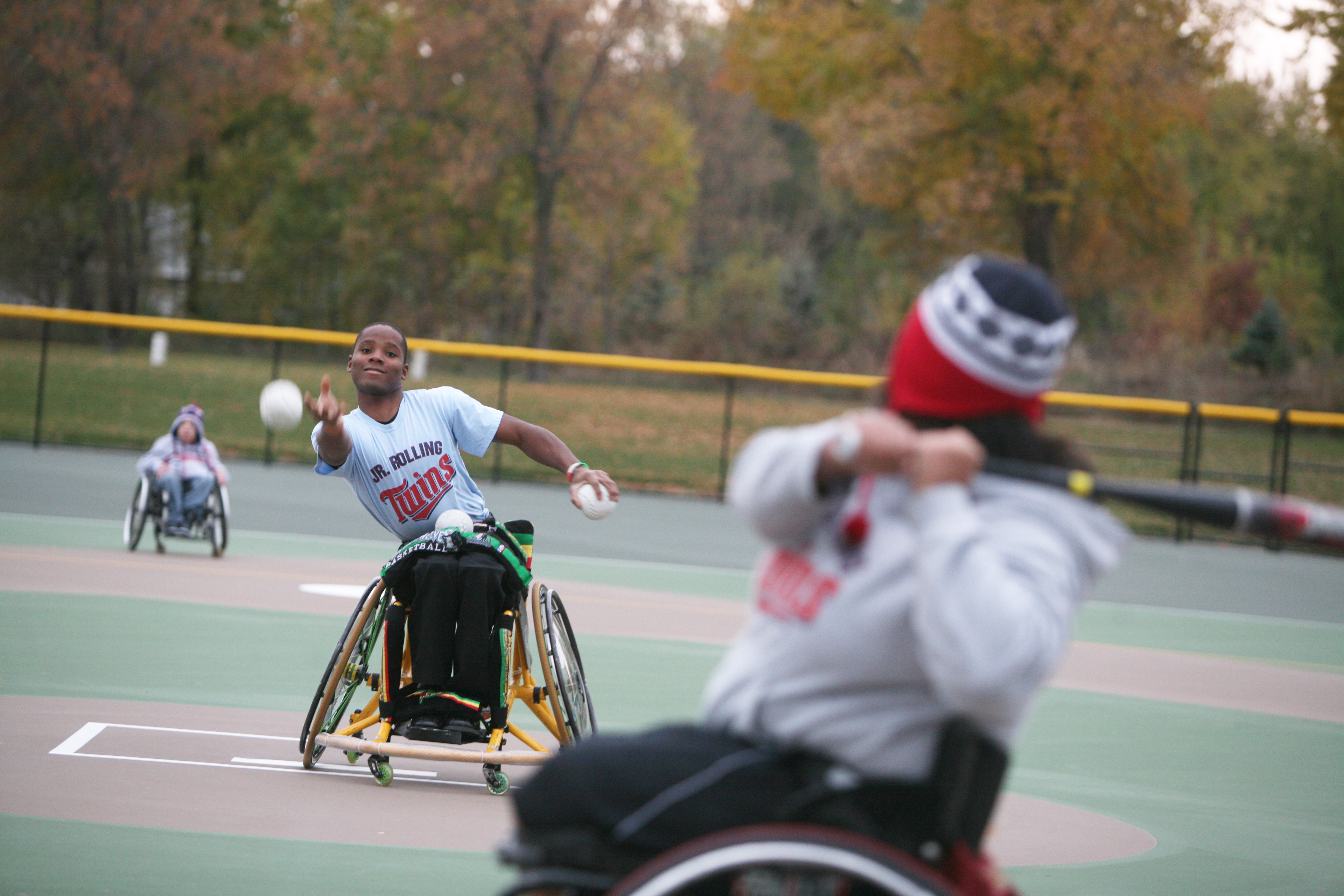 Kids playing baseball in wheelchairs