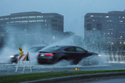 Car driving through flooded streets