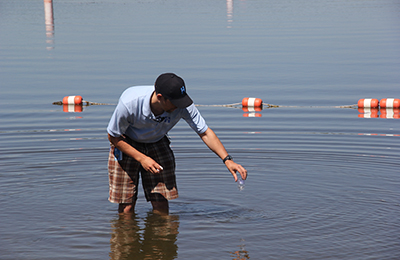 Hennepin County Public Health employee testing beach water
