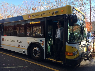 Bus driver standing at door of Metro Transit bus