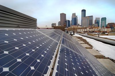 Closeup of solar panel with downtown Minneapolis in the background