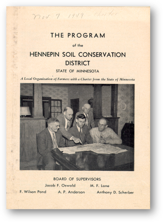 Cover of an old document with text The Program of the Hennepin Conservation District and a group of men standing around a table looking at a document