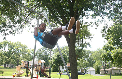 Boy swinging at playground