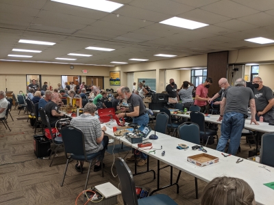 Busy room full of people fixing items