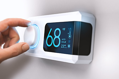 Close up of thermostat set at 68 degrees Fahrenheit.