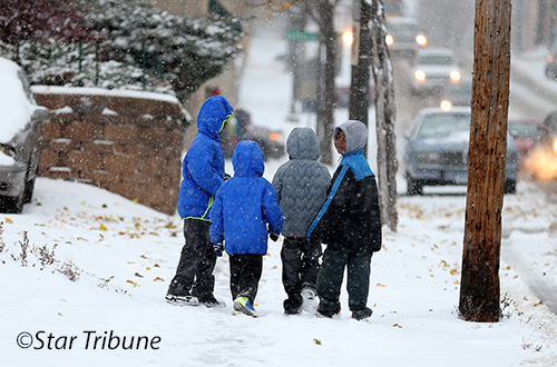 Kids walking on sidewalk in snow