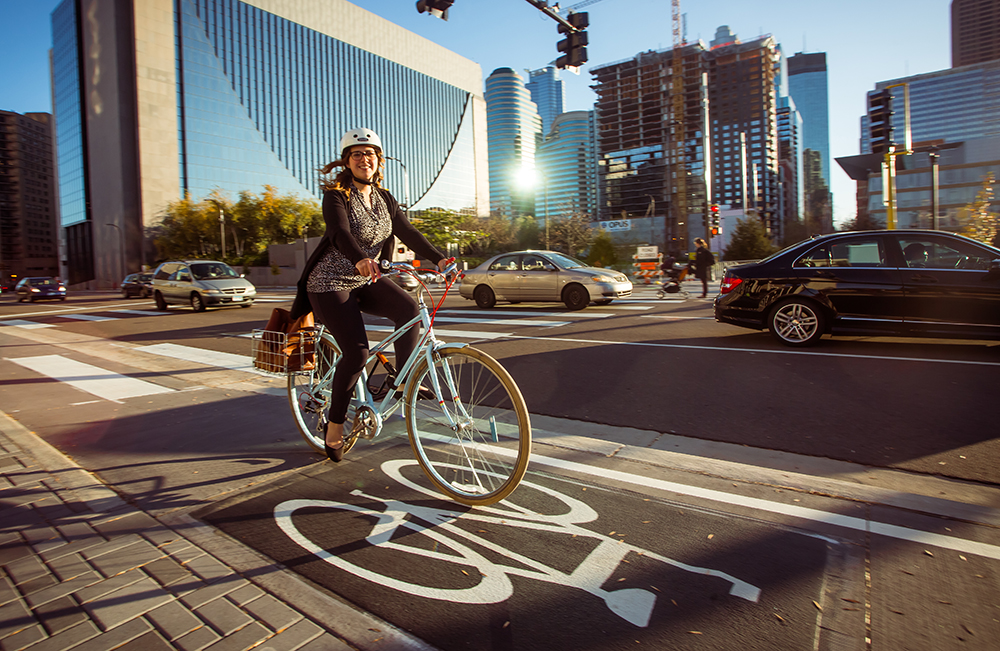 Woman biking on a designated bikeway in downtown Minneapolis