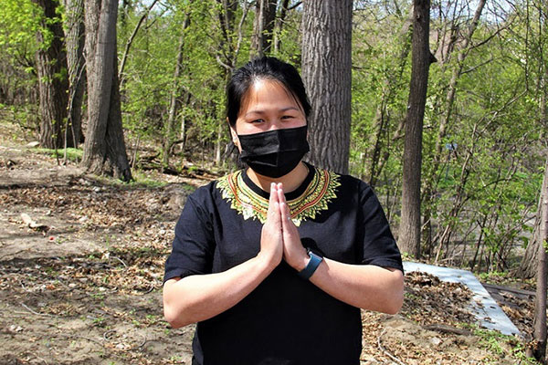 picture of community leader Korawan smiling behind her mask