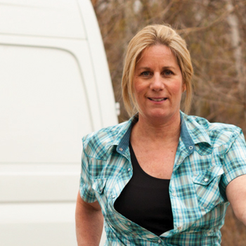 woman in front of work van
