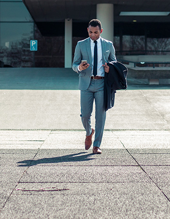 A man in a suit checking his phone