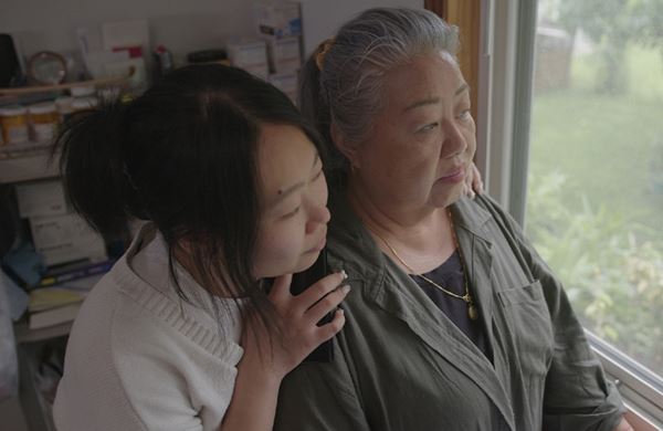 mother and daughter looking out the window
