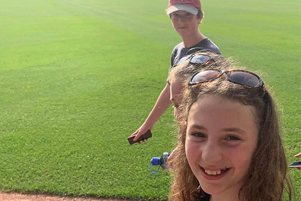 children walking on the twins field