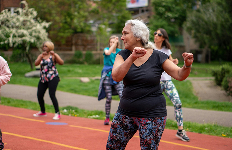 women exercising outside with other women