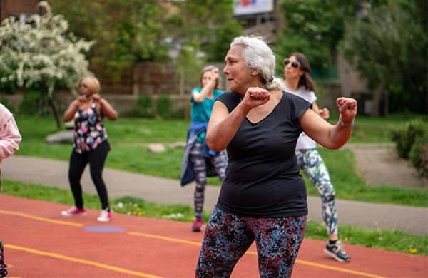 women exercising outside with other women