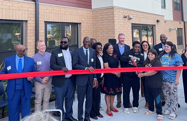 people ready to cut the red ribbon