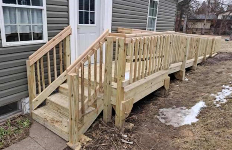 wood wheelchair ramp on the outside of a house