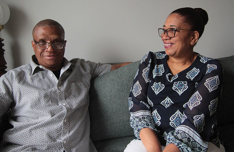 women and man sitting on a couch