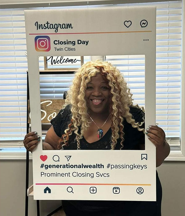 women standing inside with her face in an instagram frame